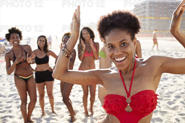 Women smiling together on beach