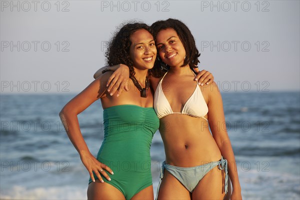 Women smiling together on beach