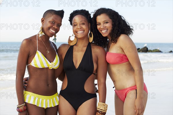 Women smiling together on beach