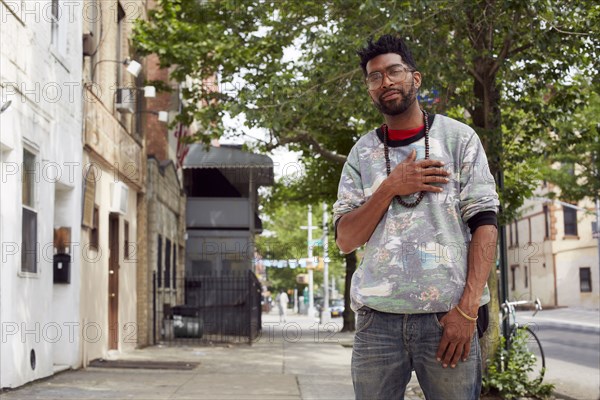 Black man standing on city street