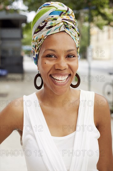 Black woman smiling on city street