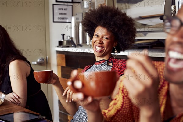 Woman laughing in cafe