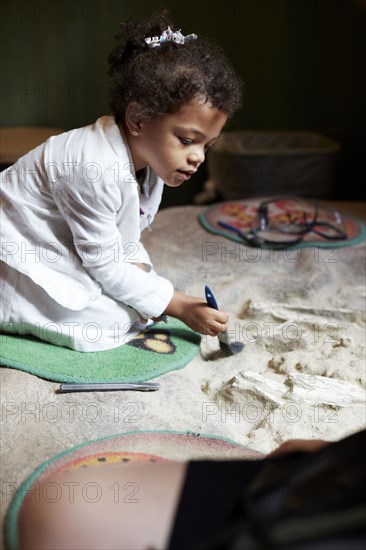 Mixed race girl painting on fabric