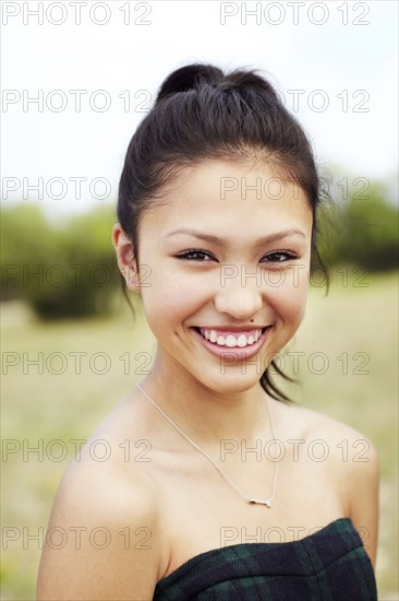 Mixed race teenage girl smiling outdoors