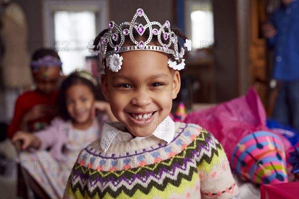 Smiling girl wearing tiara at party