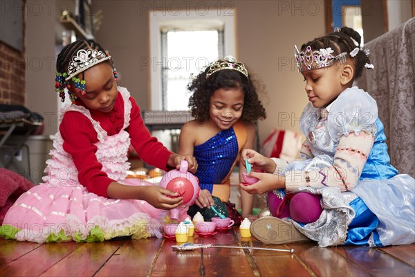 Girls playing dress-up at tea party