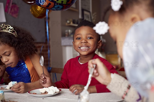 Children eating cake at party