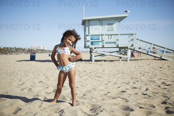 Mixed race girl wearing bikini on beach