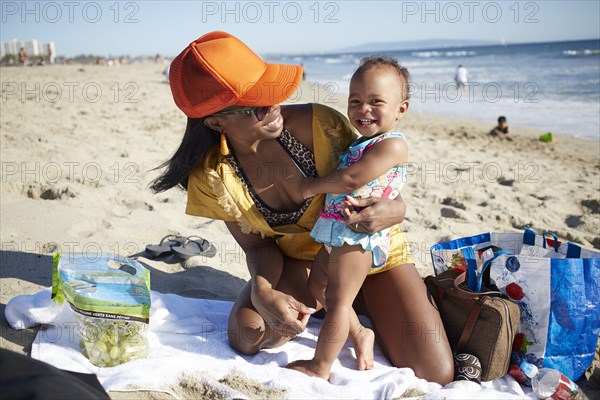 Mother and daughter playing on beach