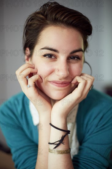 Close up of woman resting chin in hands
