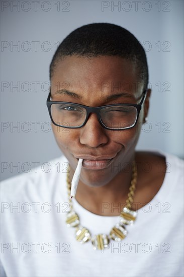 Close up of mixed race woman smoking cigarette