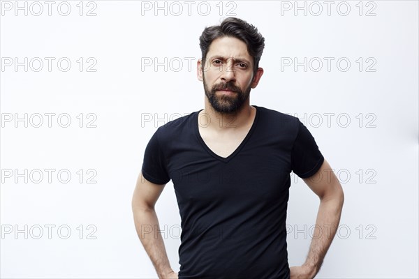 Caucasian man standing with hands on hips