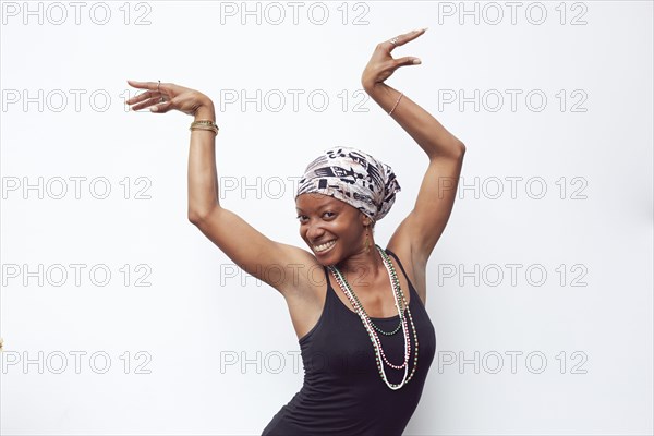 Black woman posing with arms raised