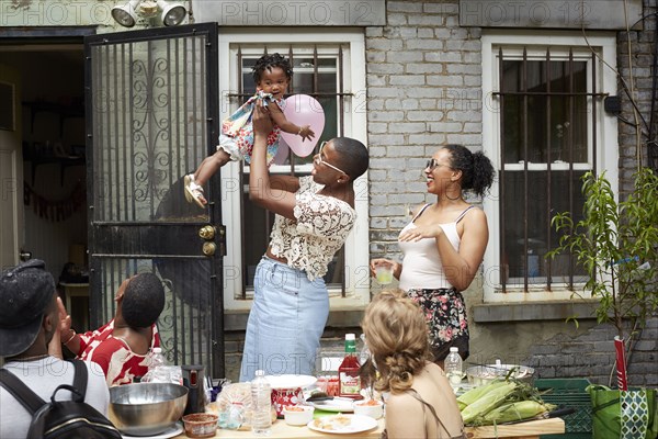 Family enjoying backyard barbecue