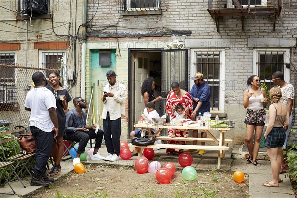 Friends enjoying backyard barbecue