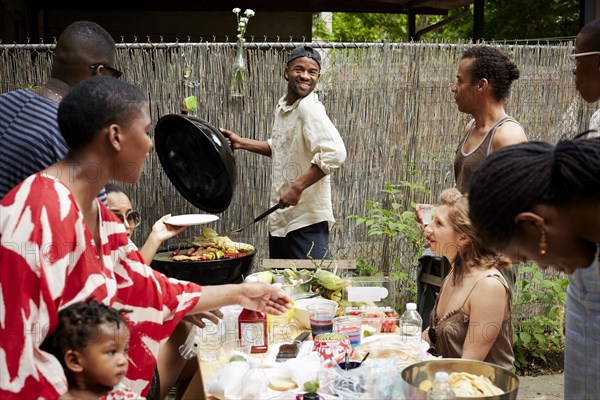 Friends enjoying backyard barbecue