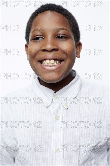 Close up of smiling boy wearing fully-buttoned shirt