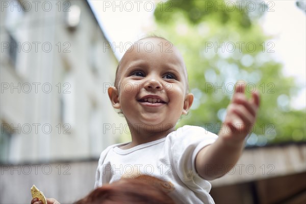 Mixed race baby boy smiling outdoors