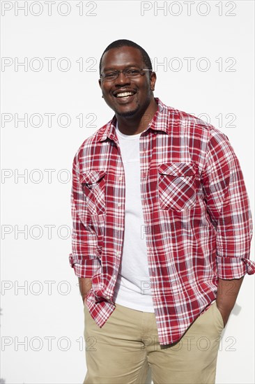 Black man standing with hands in pockets