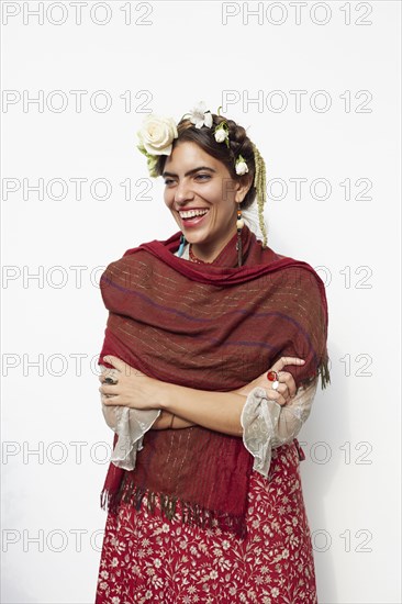 Stylish woman wearing shawl and flowers in hair