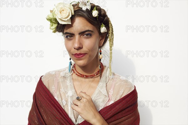 Stylish woman wearing shawl and flowers in hair