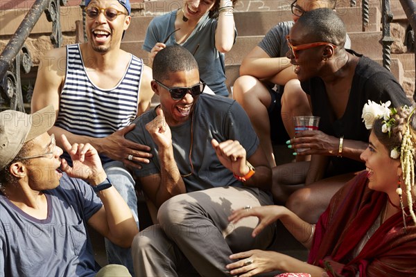 Friends relaxing on front stoop