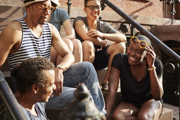 Friends relaxing on front stoop