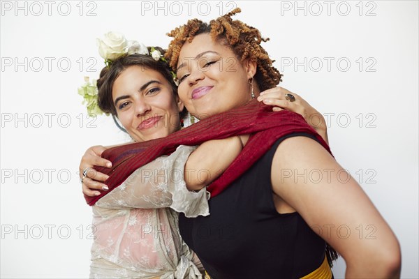 Stylish smiling women hugging