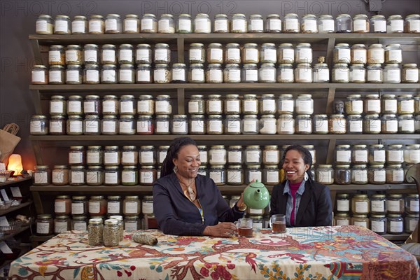 Black women drinking tea in tea shop