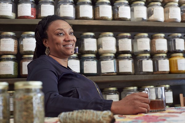 Black woman drinking tea in tea shop