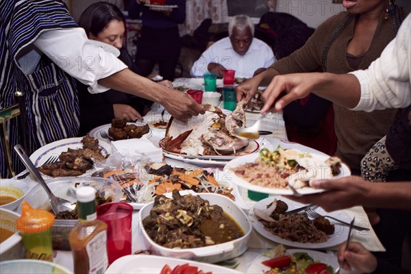 Family serving food at holiday dinner