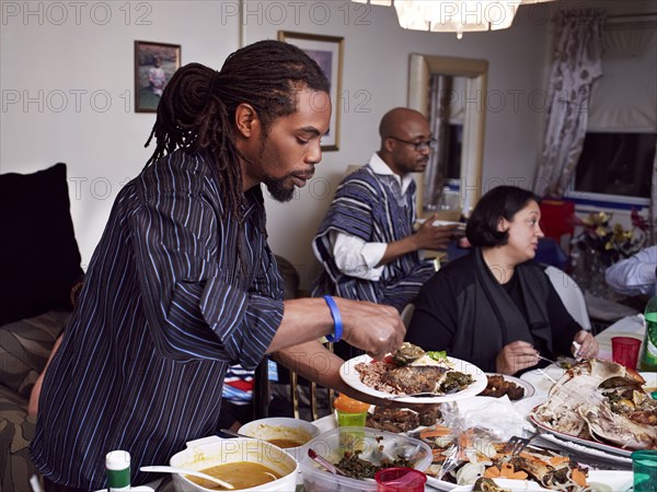 Man serving food at holiday dinner