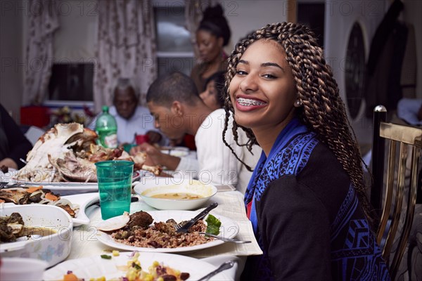 Teenage girl smiling at dinner table