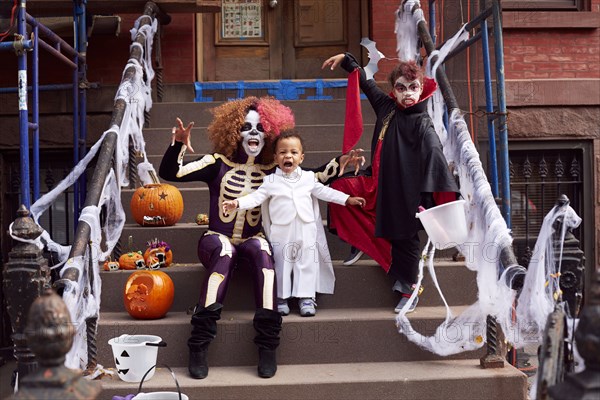 Mother and children wearing Halloween costumes