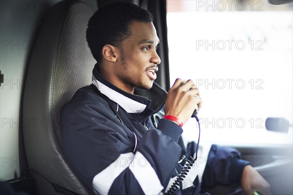 Mixed race paramedic using walkie-talkie