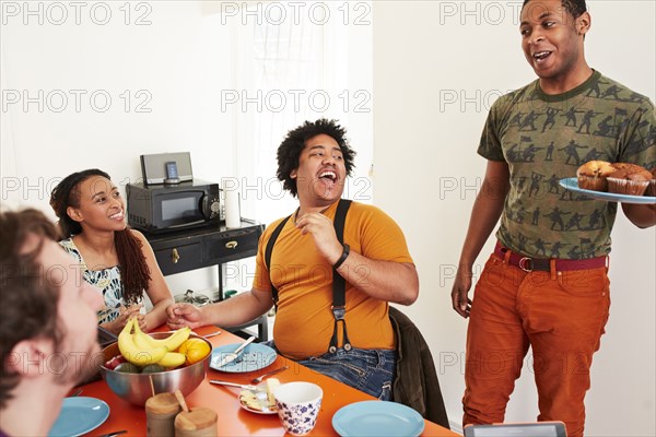 Man serving food to friends at party