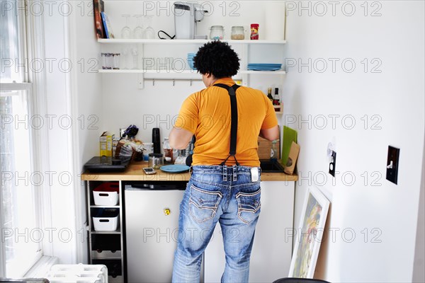 Mixed race man cooking in kitchen