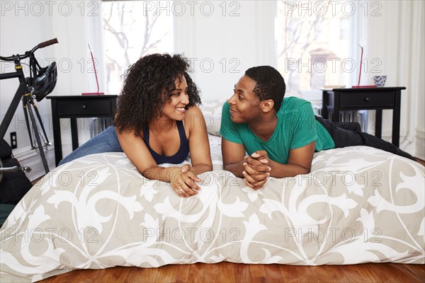 Couple talking on bed