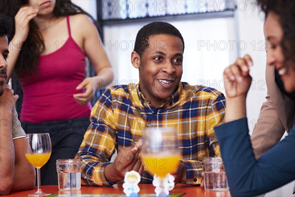 Friends playing board game at party