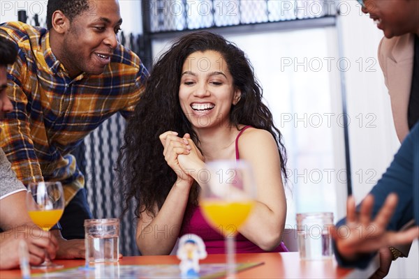 Friends playing board game at party