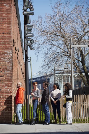 Friends waiting in line at theater