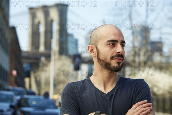 Close up of Hispanic man with arms crossed