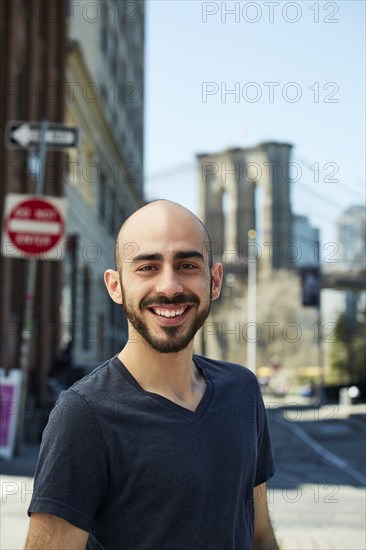 Smiling Hispanic man in city