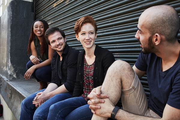 Friends talking on loading dock