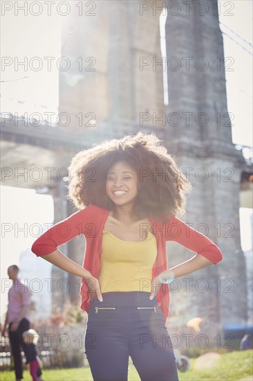 Smiling Black woman posing with hands on hips