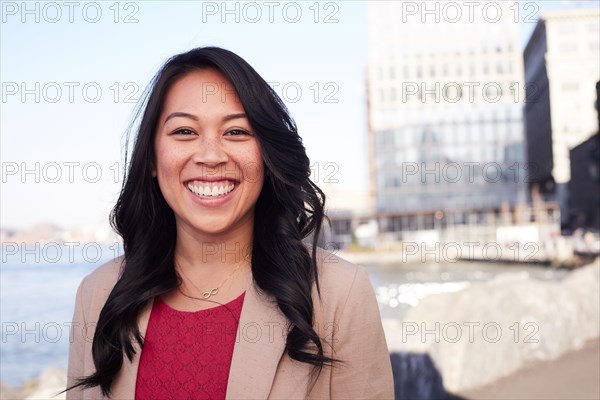 Pacific Islander woman smiling at waterfront