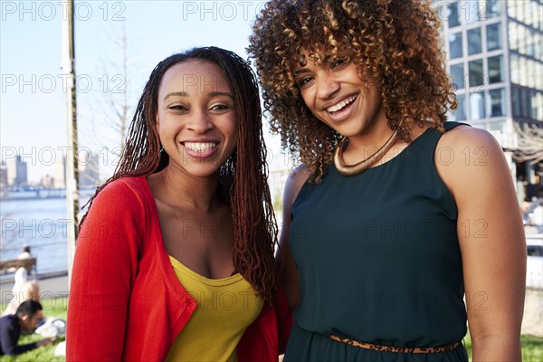 Black women smiling at waterfront