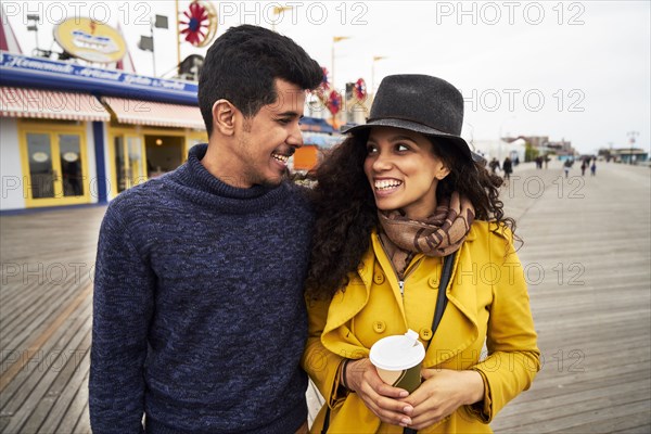 Couple on boardwalk at amusement park