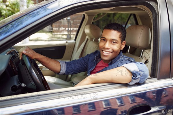 Smiling man posing in car window