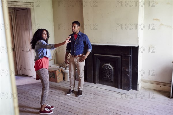 Couple talking in house under renovation